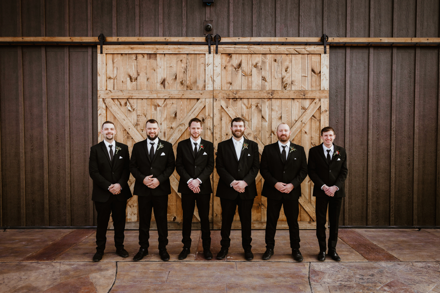 groomsmen photo in front of The Barn at Sunset Acres