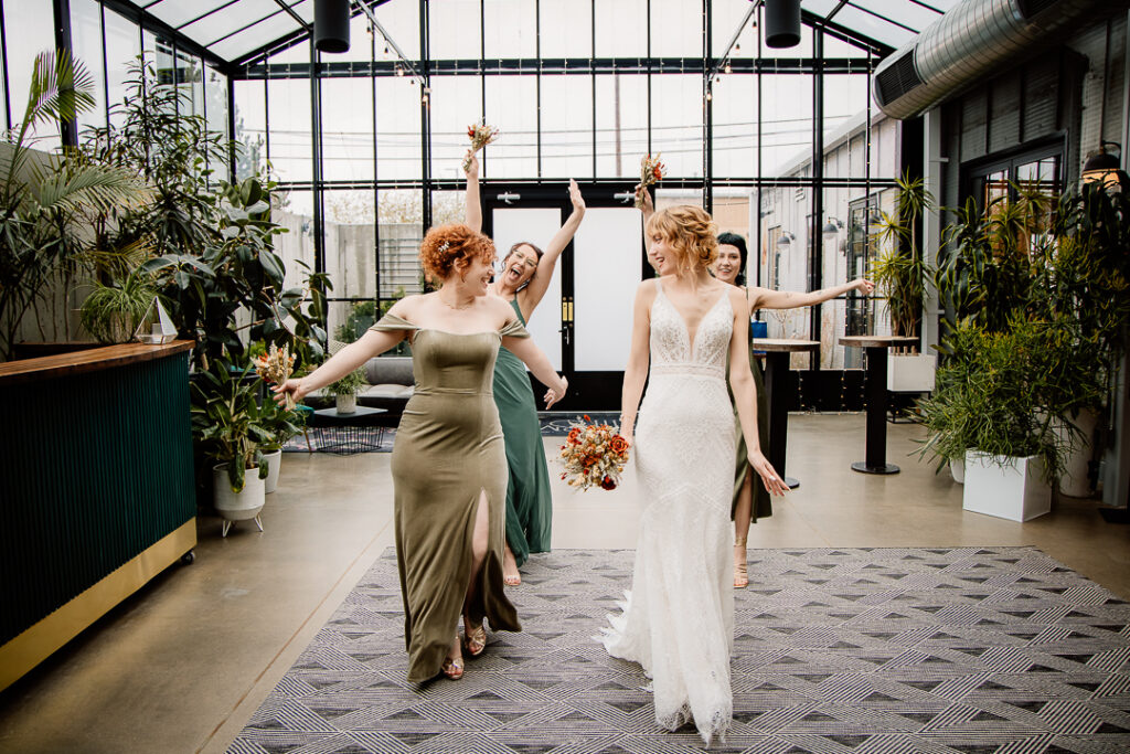 Candid photo of bride interacting with bridesmaids at The Tinsmith wedding venue in Madison, Wisconsin