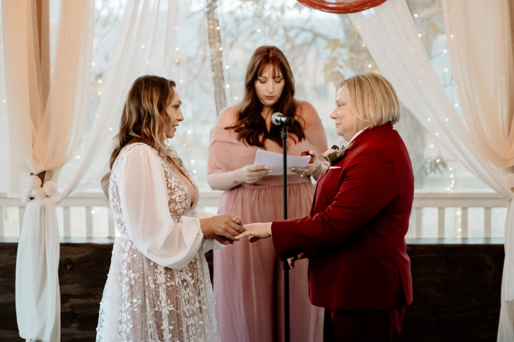 Two brides share a joyful moment during their wedding at the Old Schoolhouse in Merrimac, Wisconsin.