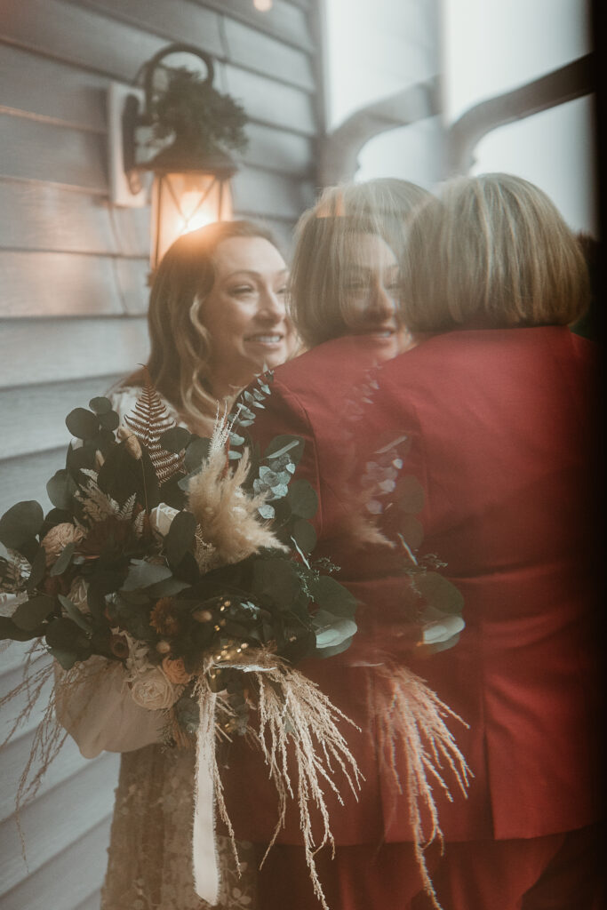 Two brides share a joyful moment during their wedding at the Old Schoolhouse in Merrimac, Wisconsin.