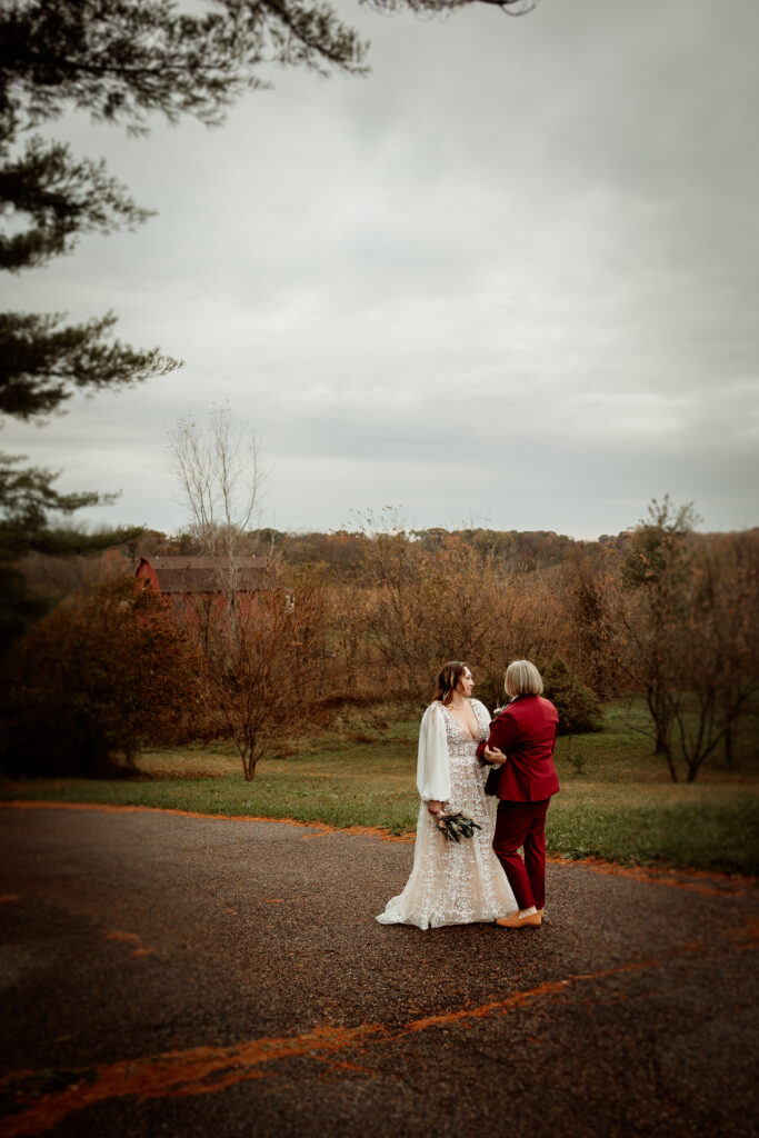 Two brides share a joyful moment during their wedding at the Old Schoolhouse in Merrimac, Wisconsin.