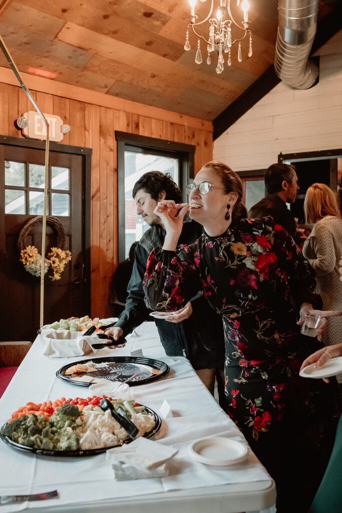 Two brides share a joyful moment during their wedding at the Old Schoolhouse in Merrimac, Wisconsin.
