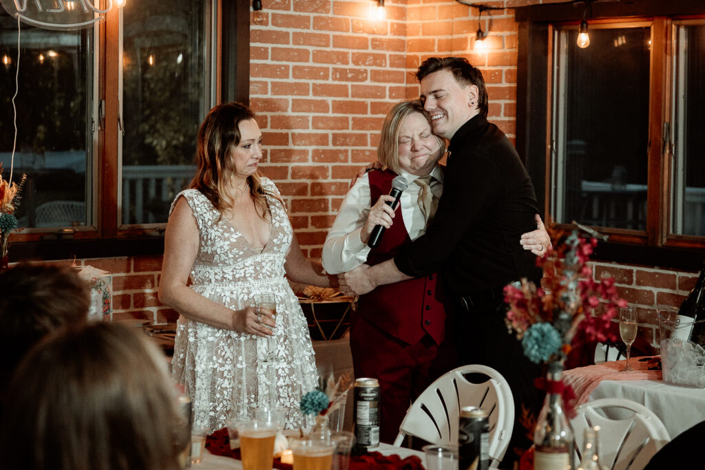 Two brides share a joyful moment during their wedding at the Old Schoolhouse in Merrimac, Wisconsin.