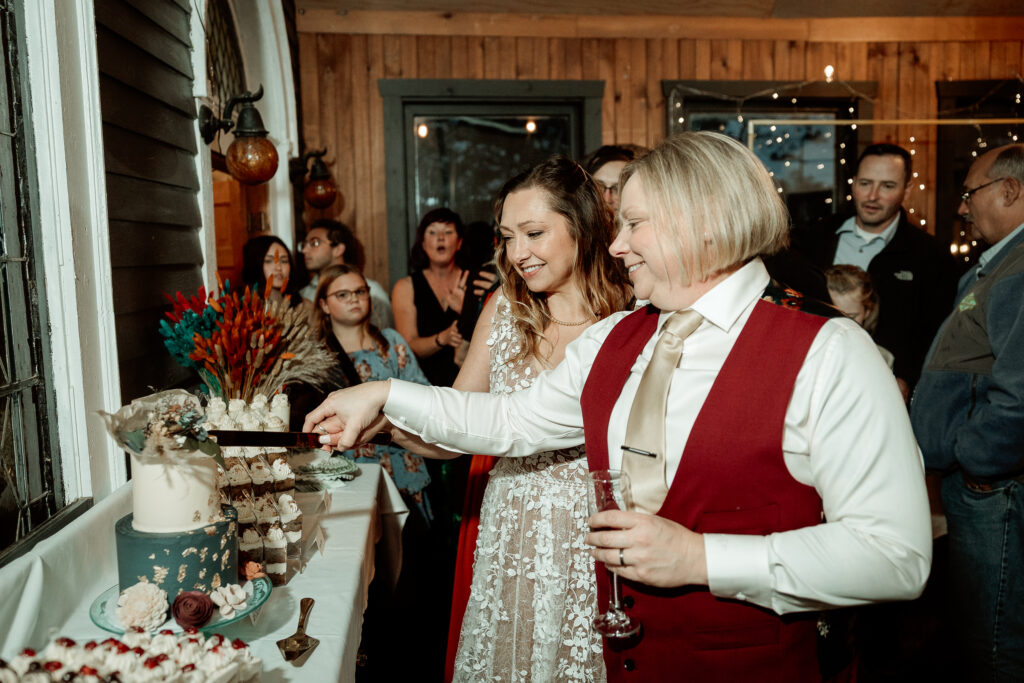 Two brides share a joyful moment during their wedding at the Old Schoolhouse in Merrimac, Wisconsin.
