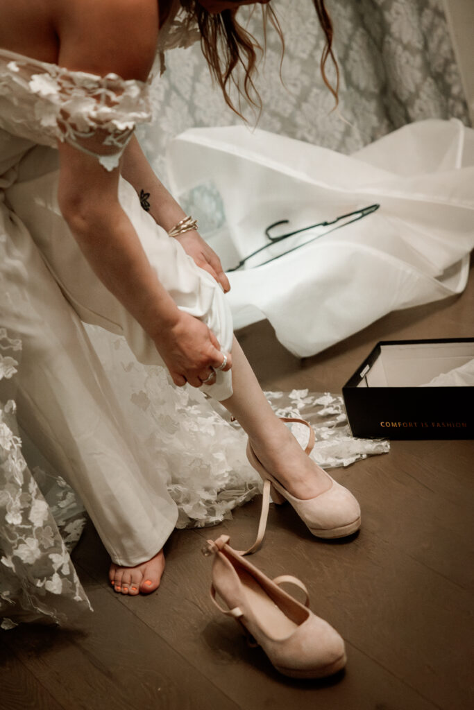 Two brides share a joyful moment during their wedding at the Old Schoolhouse in Merrimac, Wisconsin.