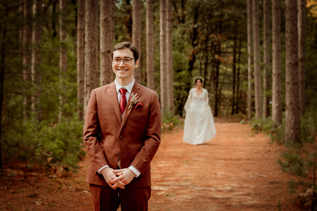 Bride and Groom's first look in the pines at Burlap and Bells in Black River Falls, WI