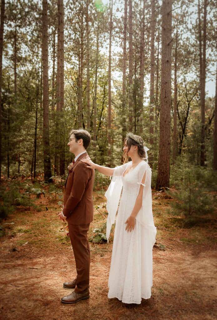 Bride and Groom's first look in the pines at Burlap and Bells in Black River Falls, WI
