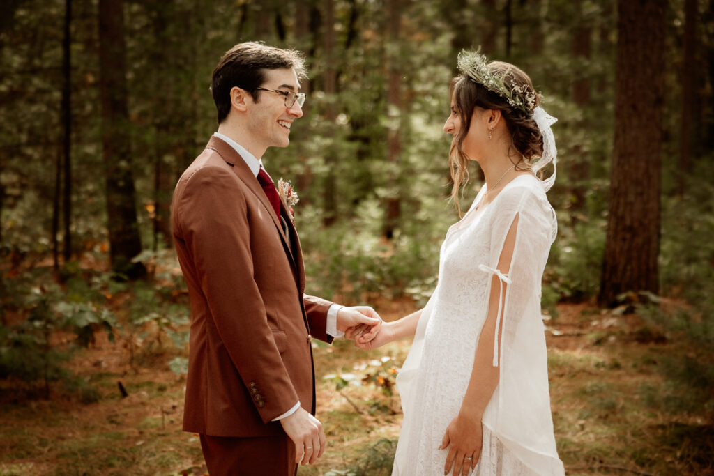 Bride and Groom's first look in the pines at Burlap and Bells in Black River Falls, WI