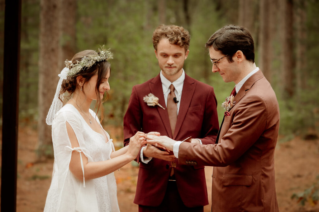 Bride and Groom preforming a handfasting during their ceremony at Burlap and Bells in Black River Falls, WI
