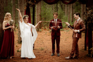 Bride and Groom preforming a handfasting during their ceremony at Burlap and Bells in Black River Falls, WI