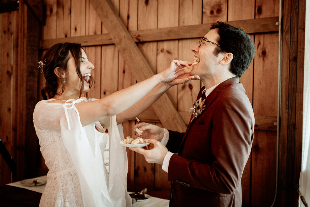 Bride and Groom's cake cutting during their reception at Burlap and Bells in Black River Falls, WI